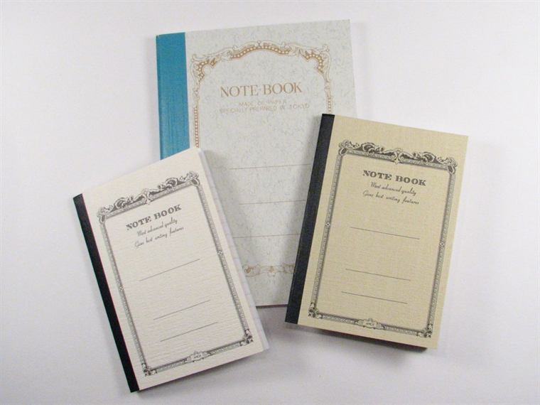 A notebook open beside a working pen